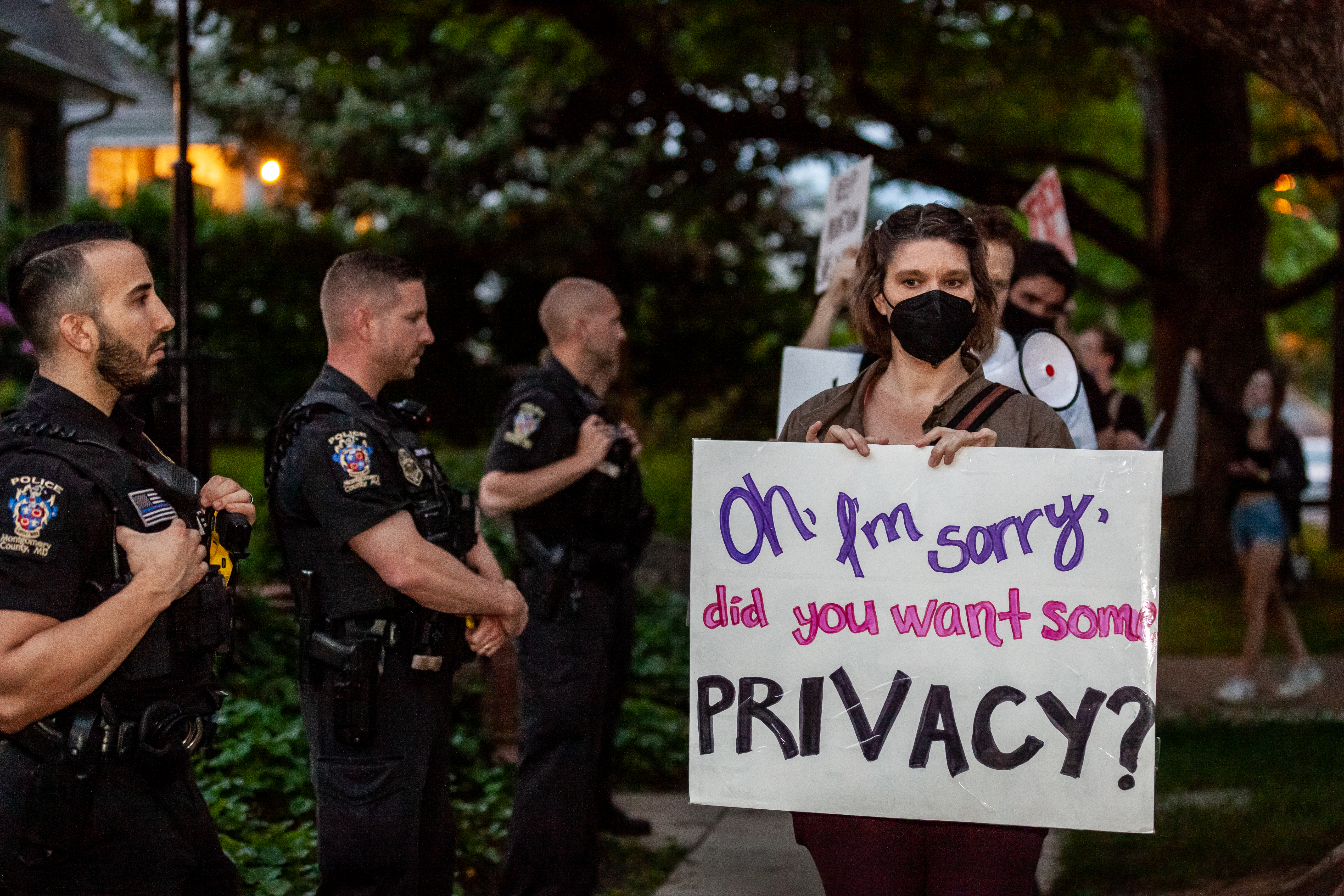 Pro-choice protesters walk past police and federal marshals standing in front of Justice Brett Kavanaugh's house in Chevy Chase, MD.  Demonstrators began protesting outside the justice’s homes after the leak of the draft opinion that would overturn Roe v. Wade. (Photo by Allison Bailey/NurPhoto)NO USE FRANCE